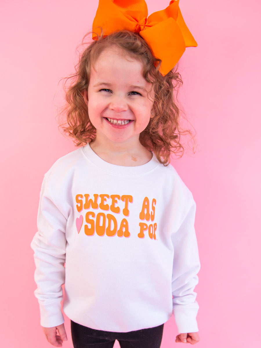 Little Girl wearing Orange Type on White Sweatshirt