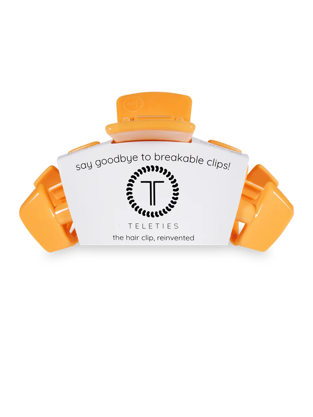 orange hair claw clip with teleties label on it