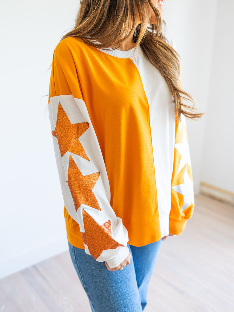 Orange and white top with glitter stars sleeves