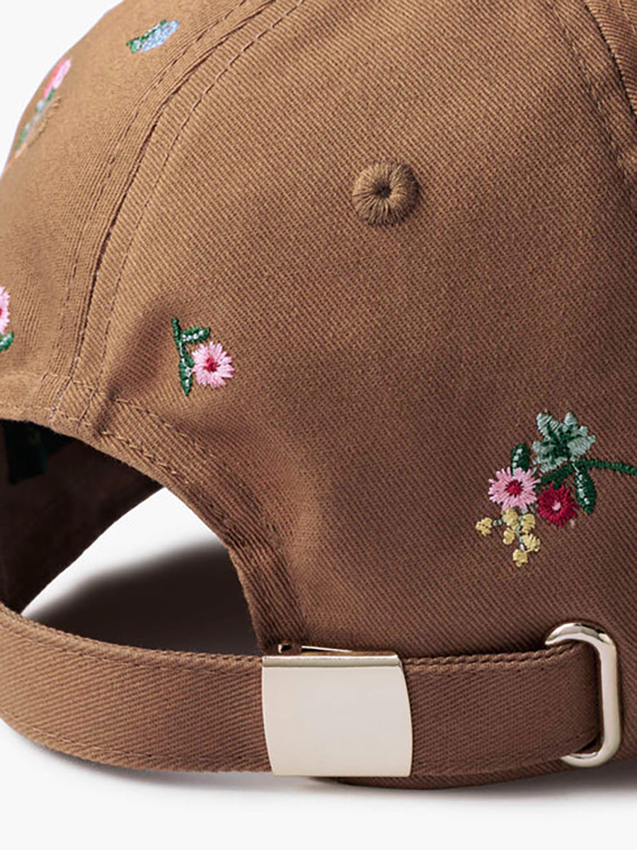closeup of embroidered flowers on brown cap