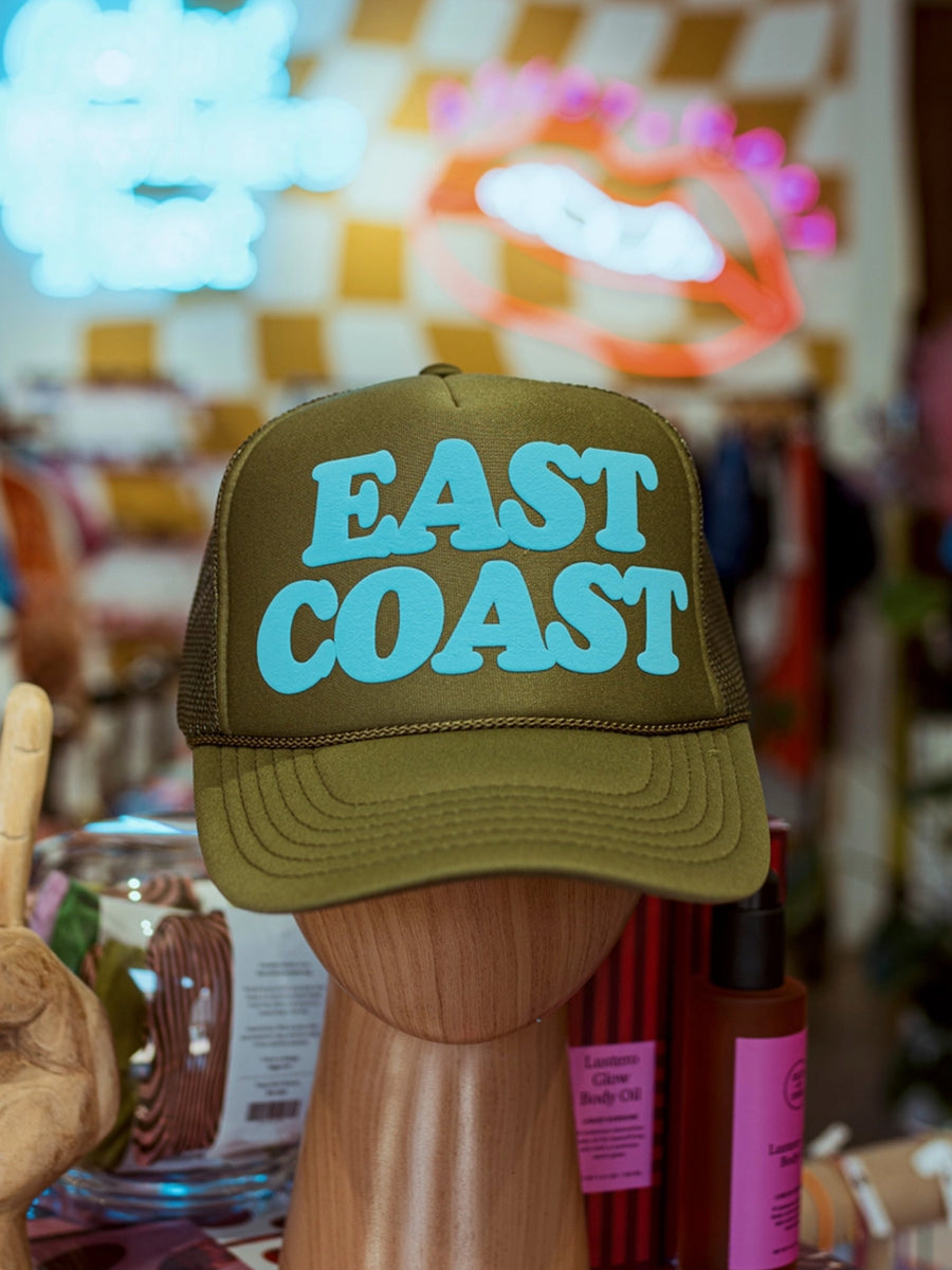 Olive green trucker hat with 'EAST COAST' in aqua blue