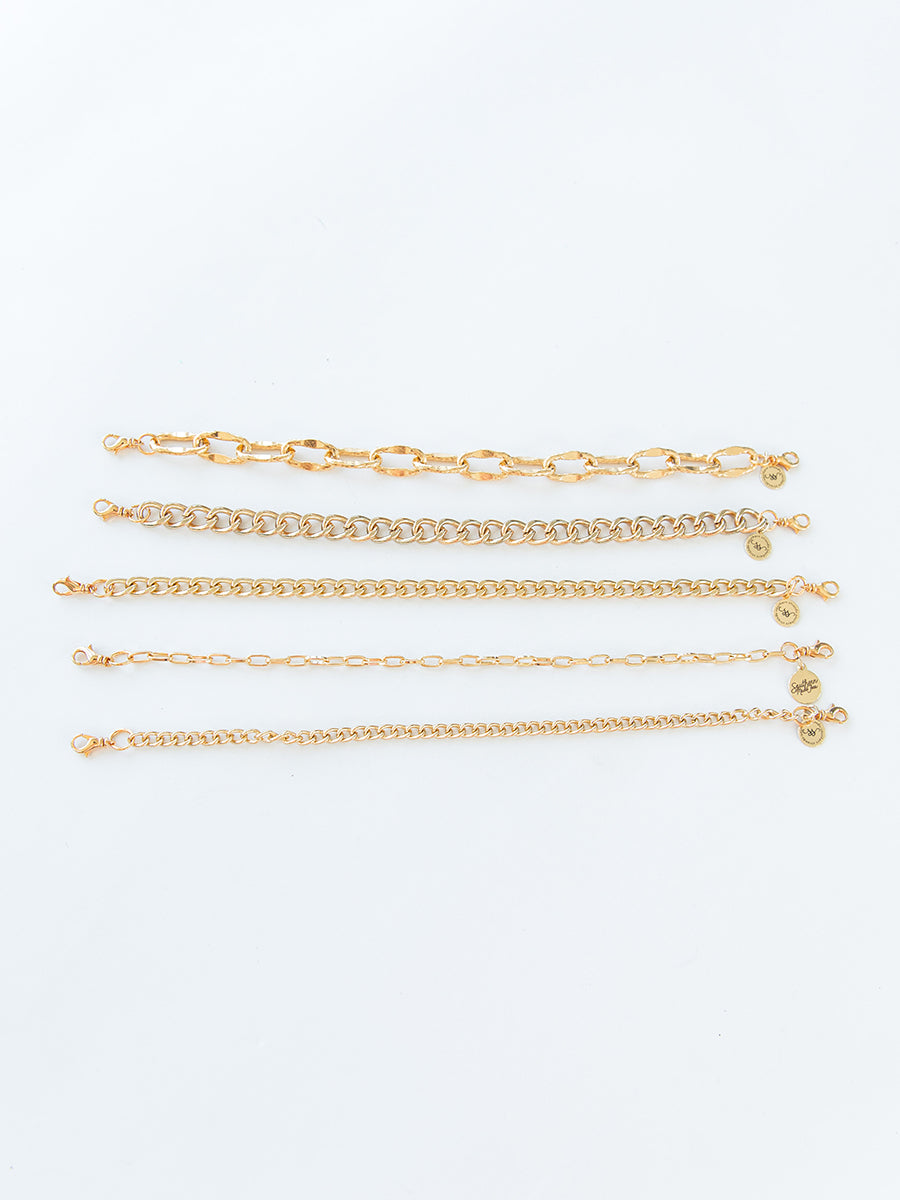 full view of 5 gold chains lying parallel