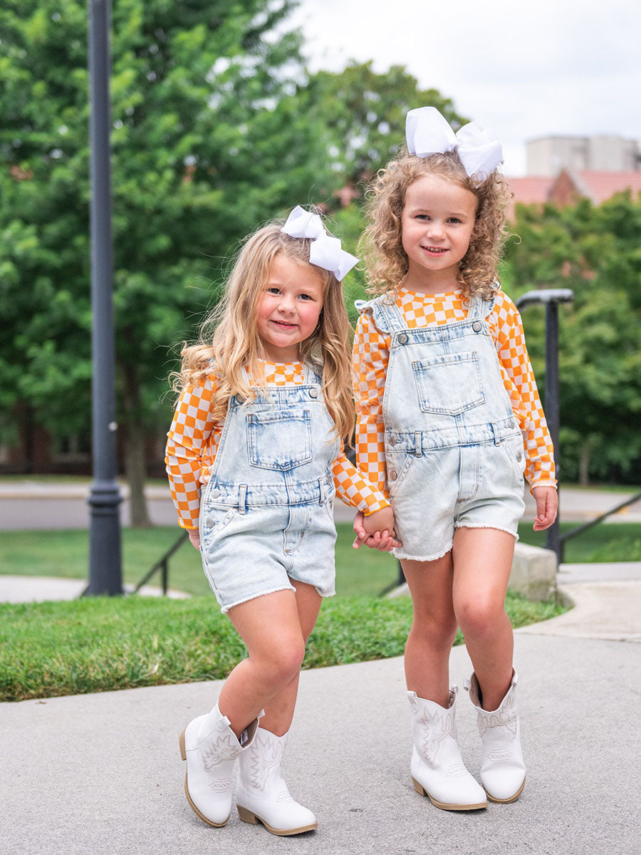 orange and white mesh checkered tops under overalls