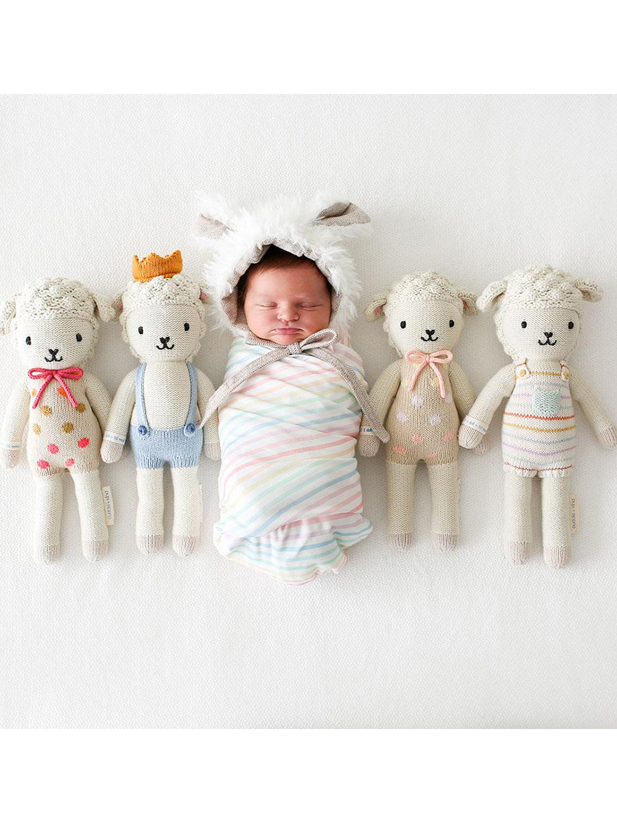 Shows doll size in relation to a baby