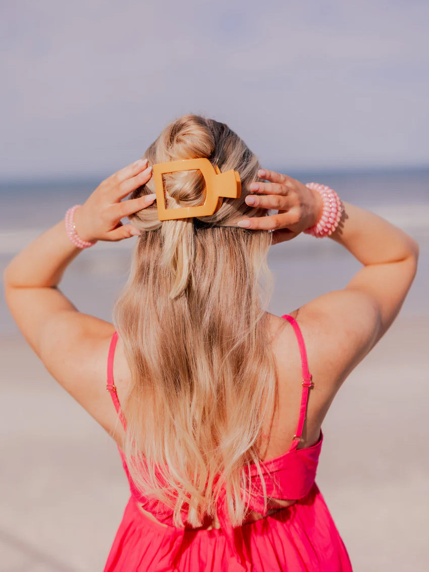 large orange hair clip in woman's hair