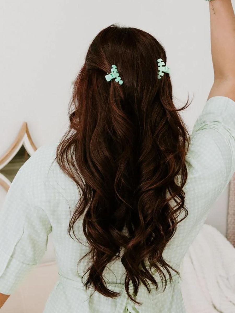 two mint tiny hair claws in woman's hair