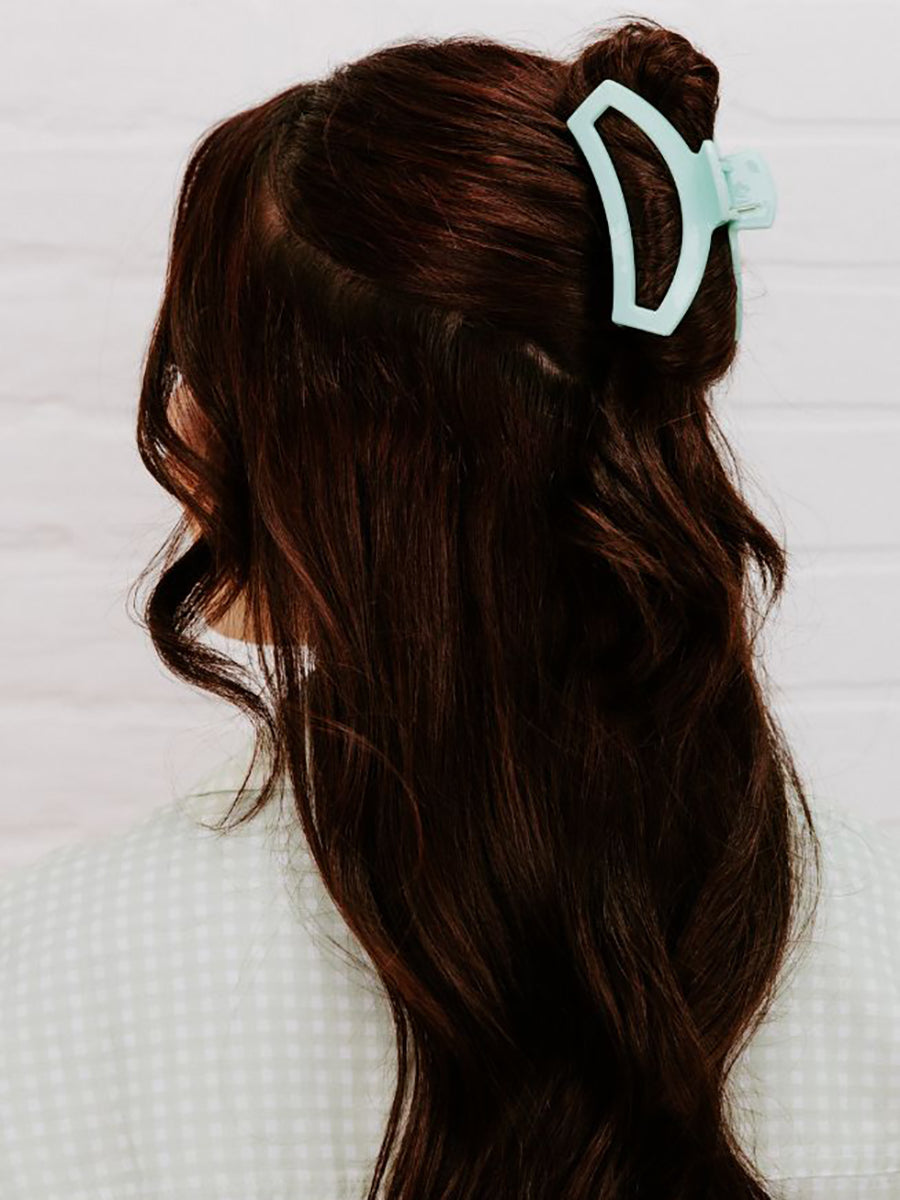 mint green hair clip in woman's hair