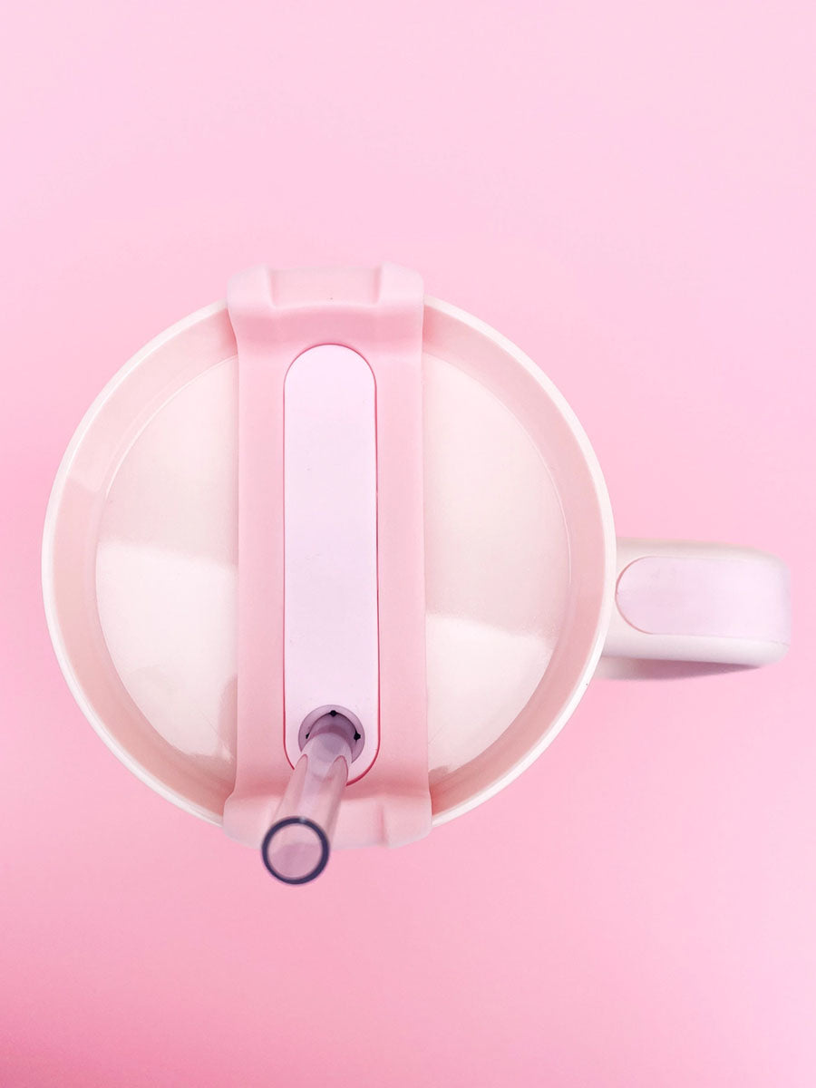 cream and pink tumbler with straw