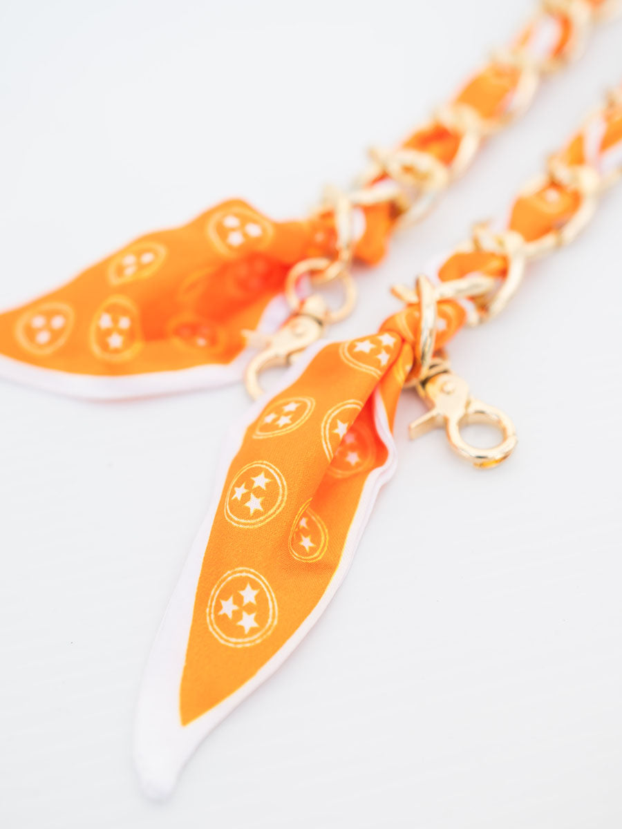 orange and white scarf and chain purse strap