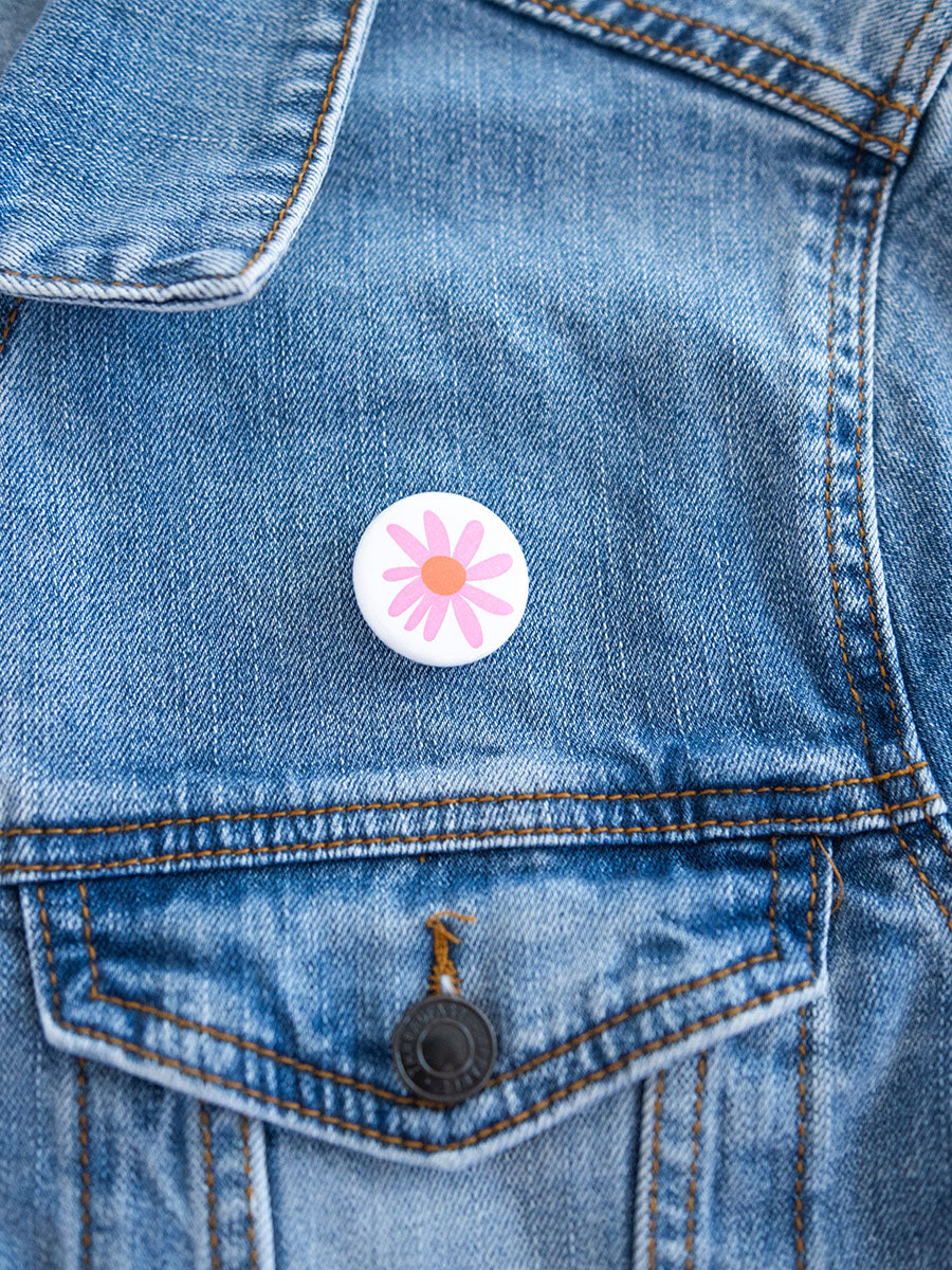 1" button with a pink flower