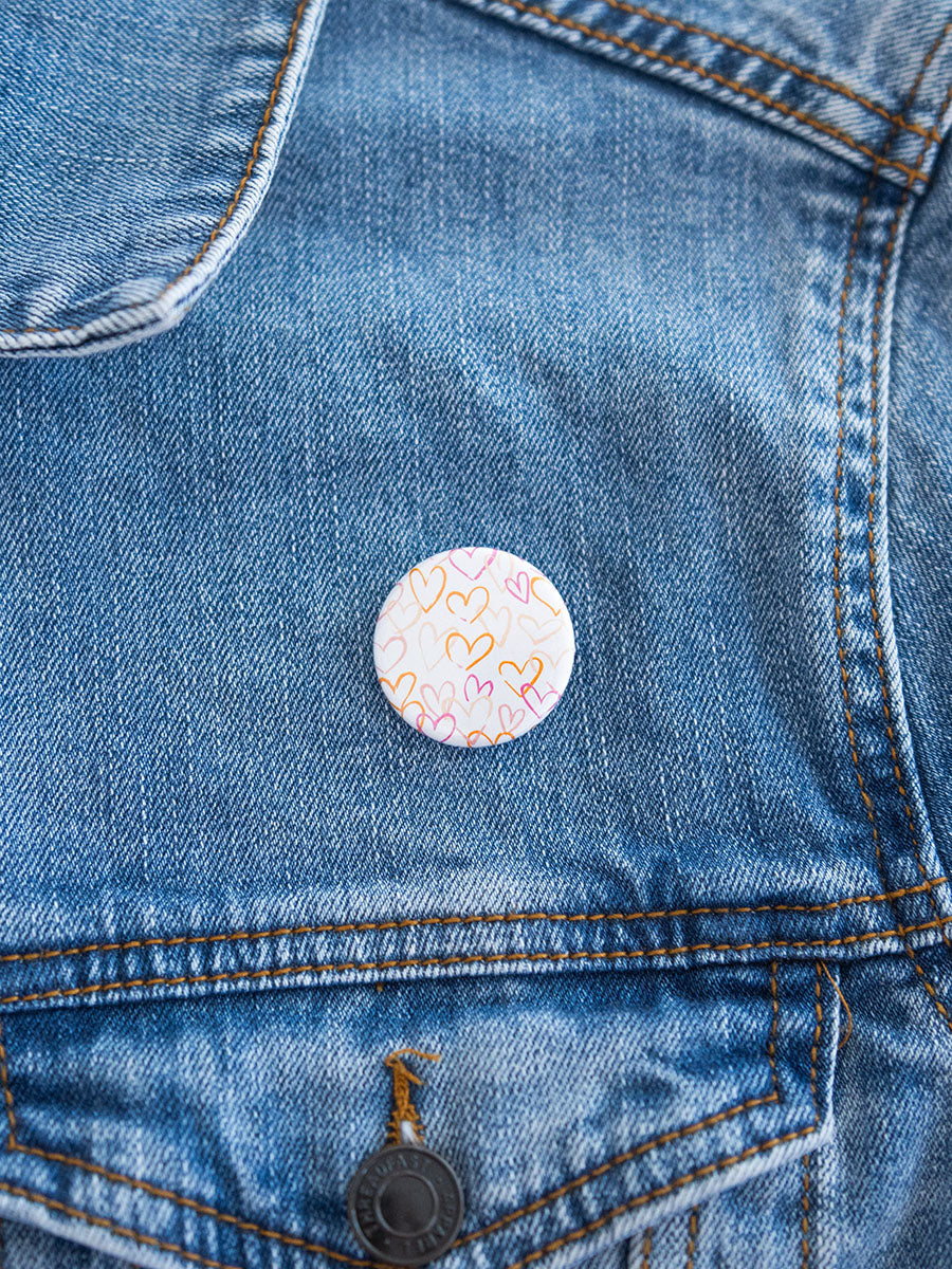 1" button with pink and orange hearts