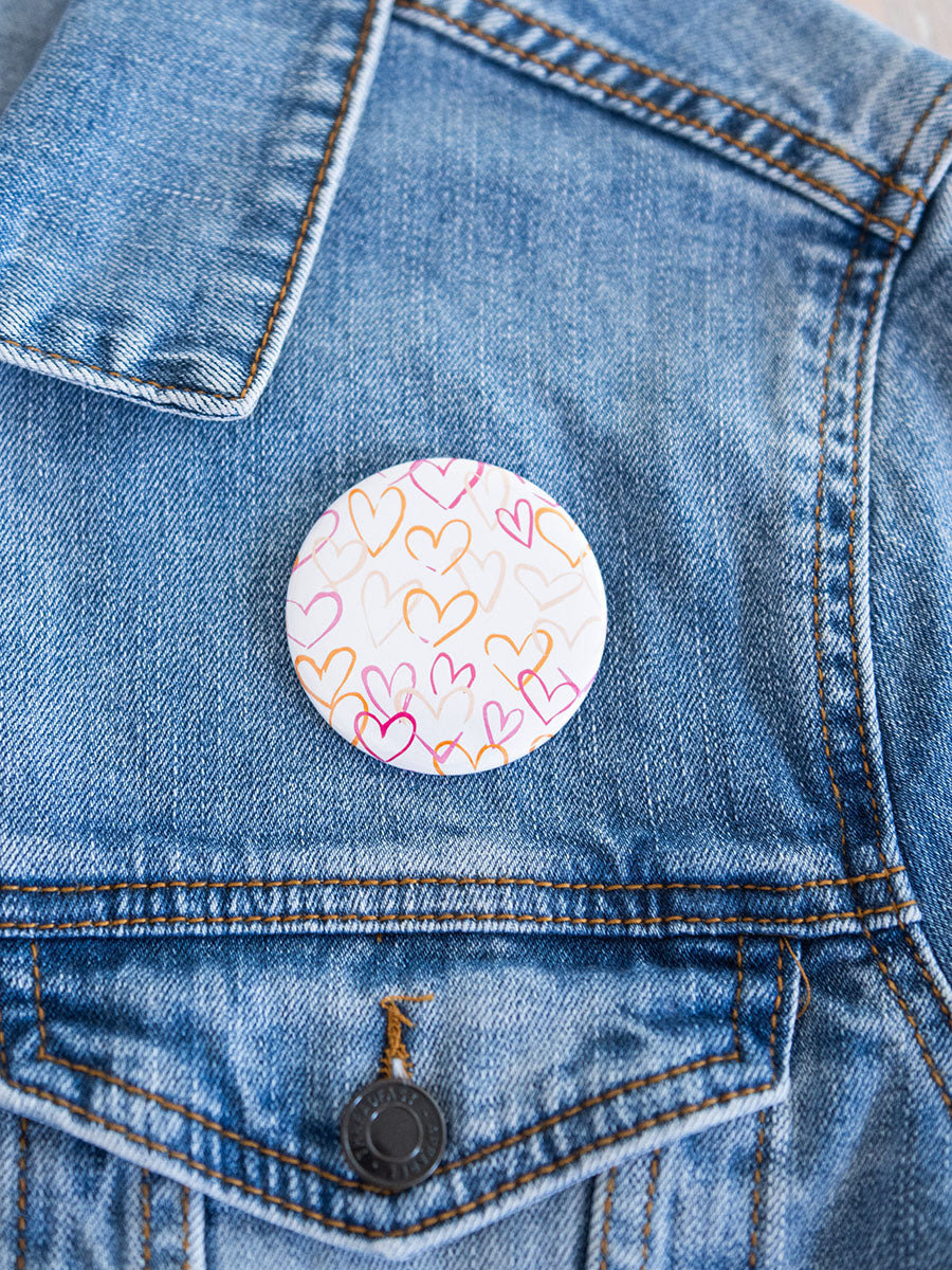 2" button with pink and orange hearts