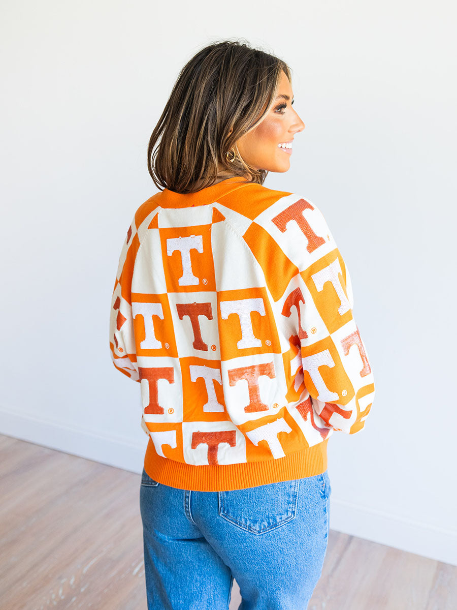 orange and white checkered cardigan