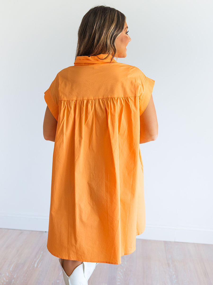 Back of orange shirt dress