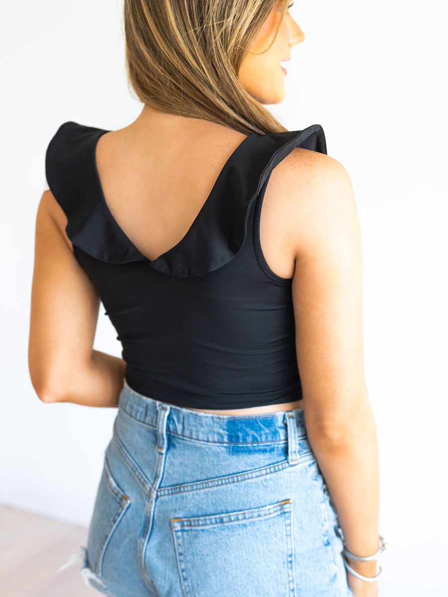 Back of black ruffle crop top