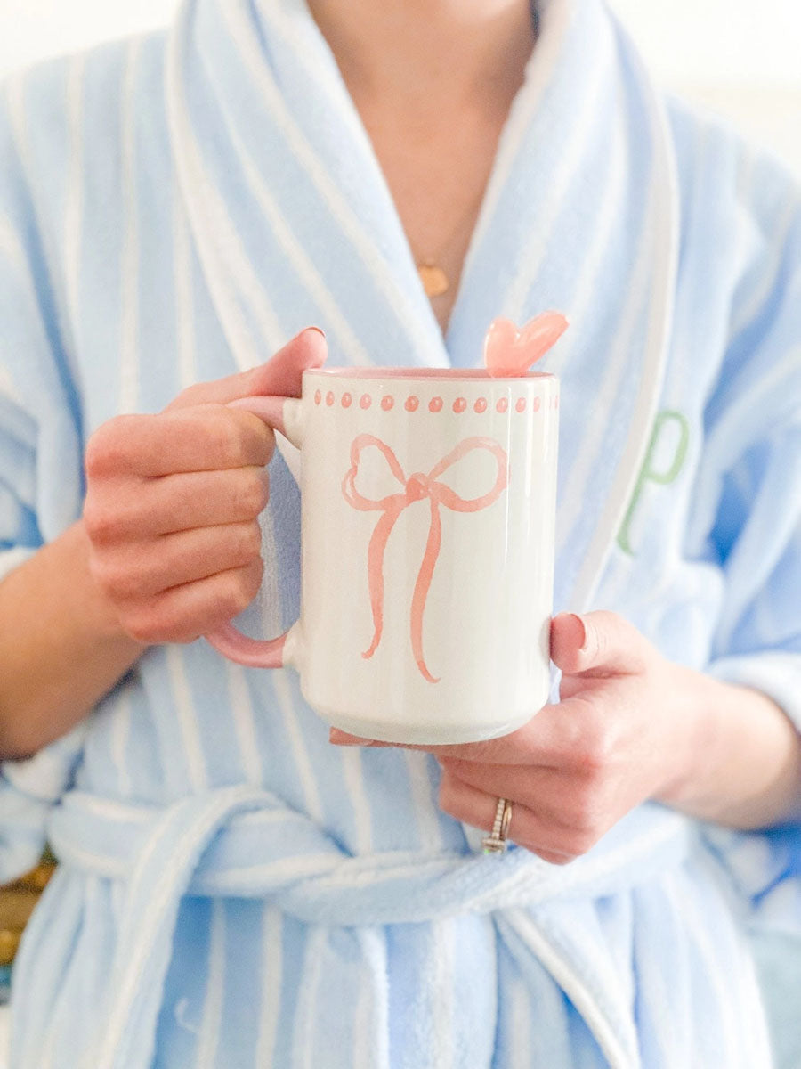 Model holding a pink bow mug