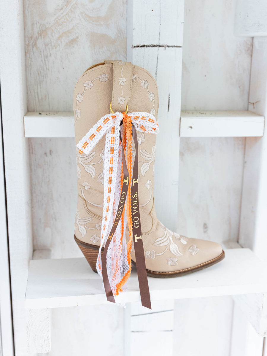 Decorative ribbons on tan boots