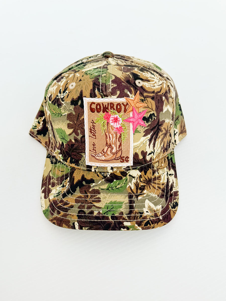 Camo hat with cowboy postage stamp patch