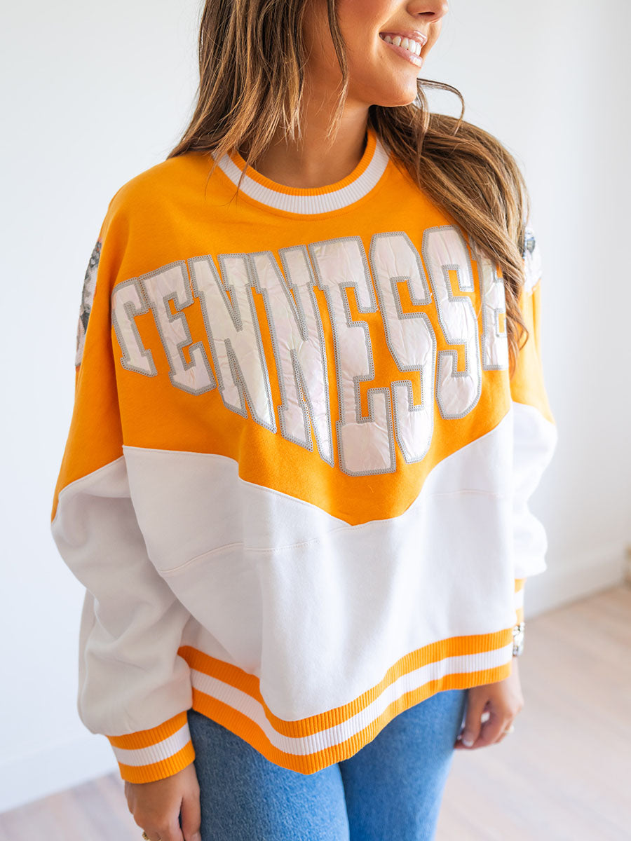 Tennessee in holographic letters on orange and white sweatshirt