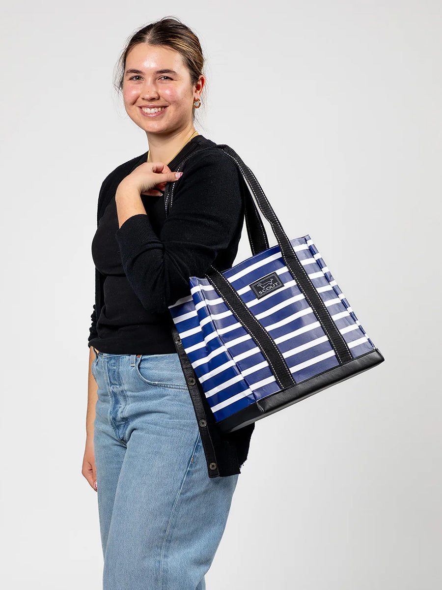 Woman carrying striped tote bag