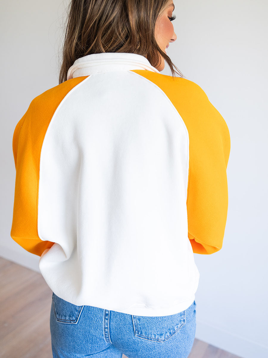 back of orange and white color block sweatshirt