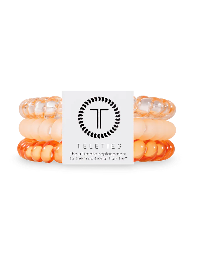 3 spiral hair ties in shades of orange and peach