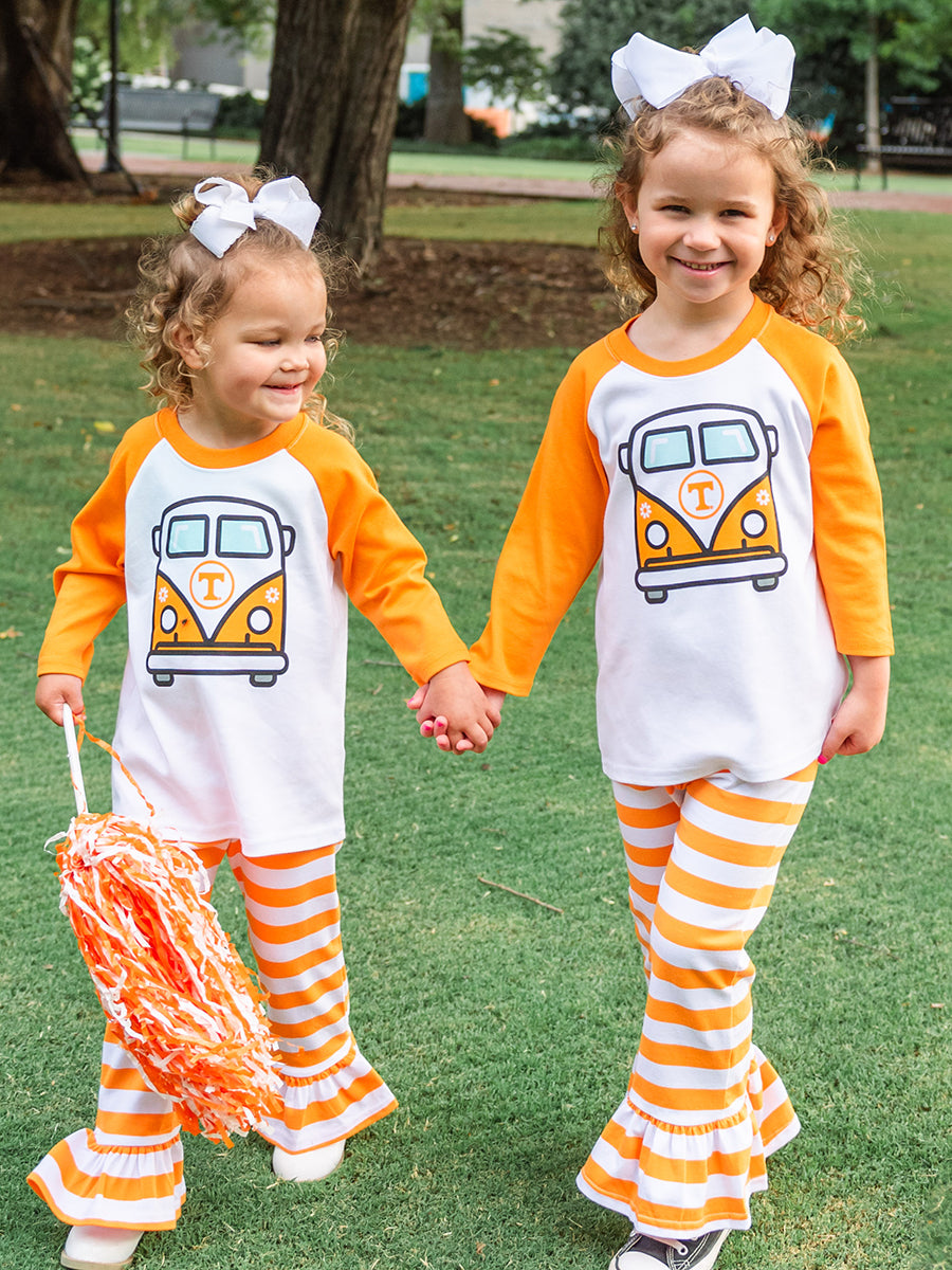 girls wearing orange and white raglang t-shirt with orange and white van on it