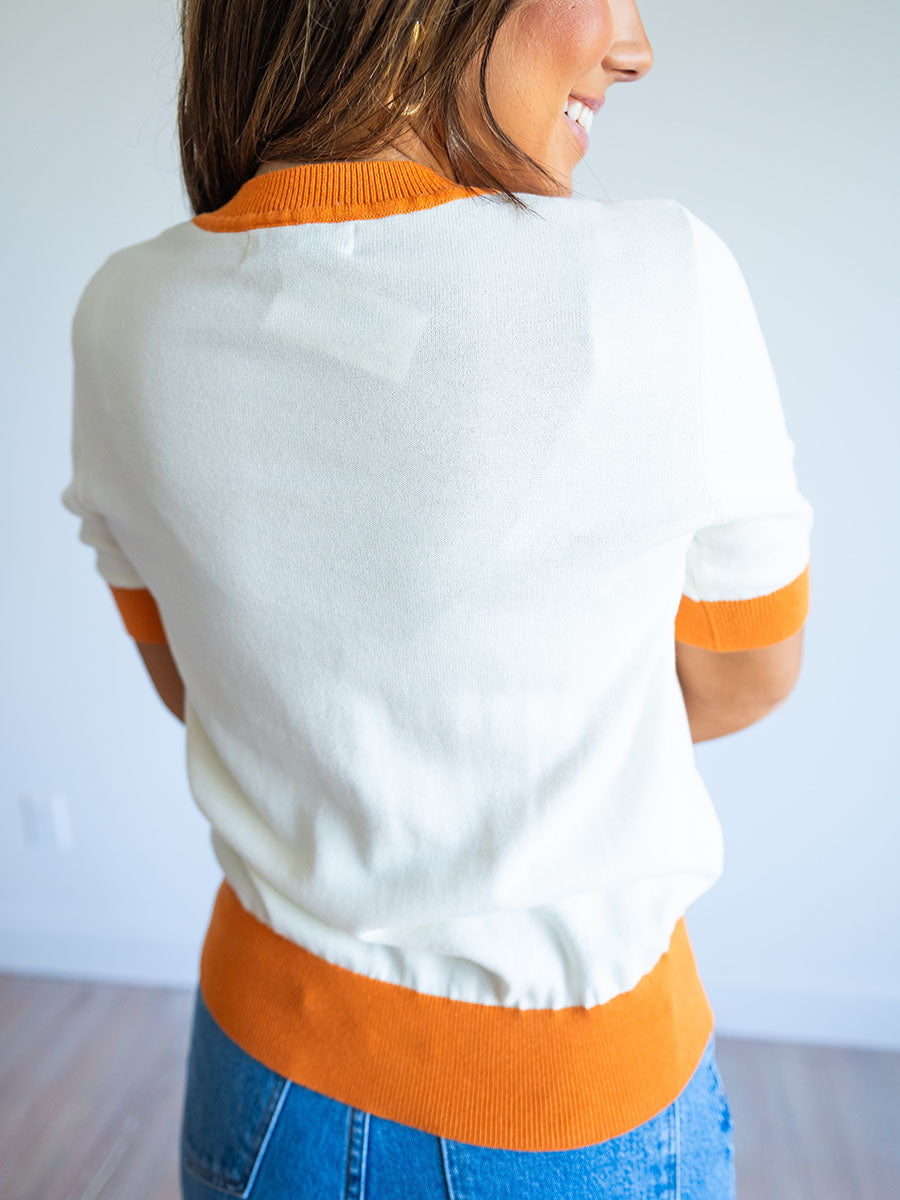 cream and orange short sleeve sweater top