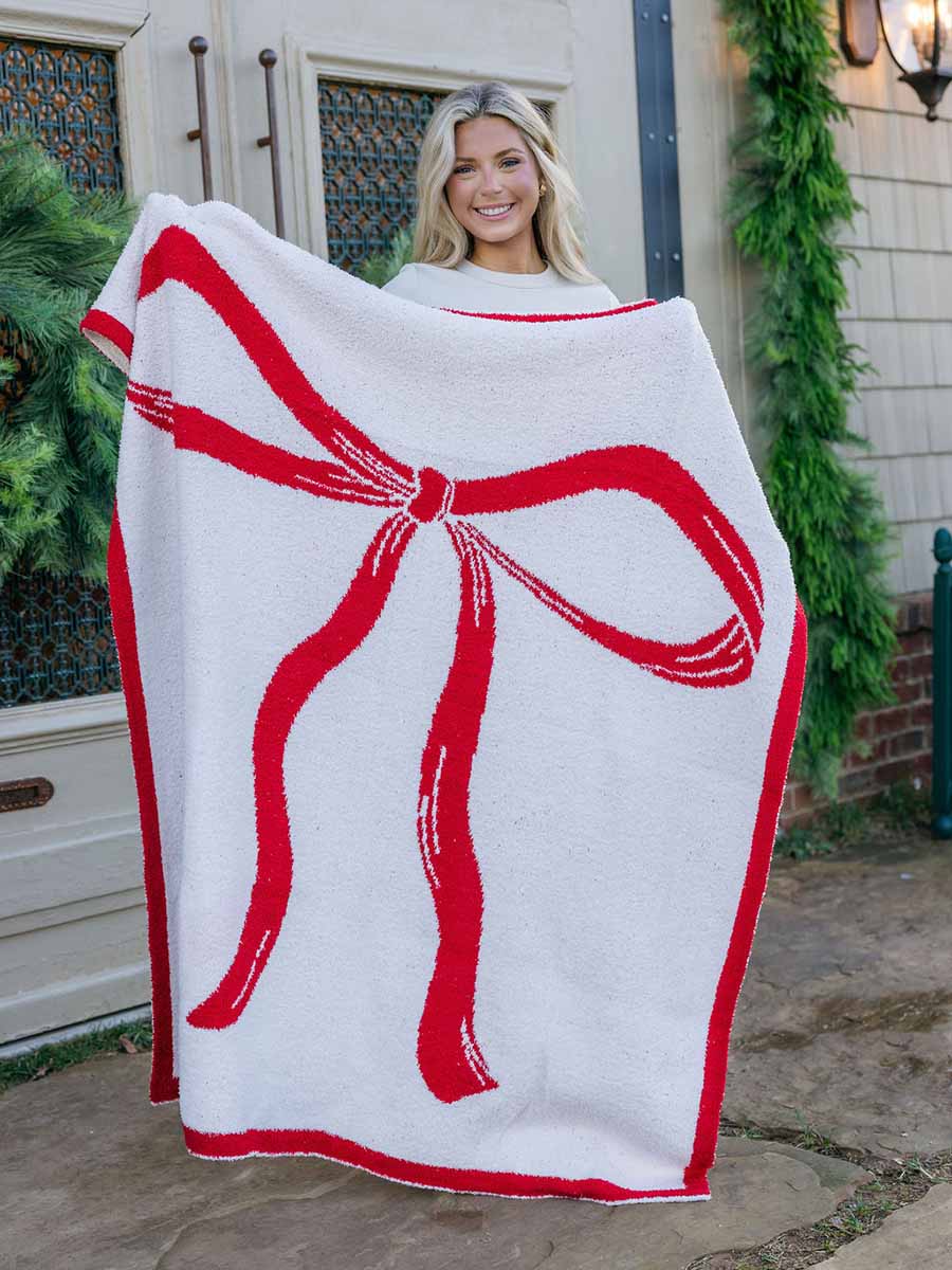 White Blanket with Red Christmas Bow